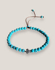 Pulsera con tortuguita plateada y lava azul turquesa