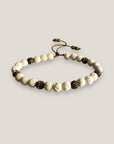 Pulsera Dafne con esponja coral blanca y filigrana bronce con cristalitos blancos