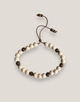 Pulsera Dafne con esponja coral blanca y filigrana bronce con cristalitos blancos