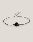 Pulsera minimal con bola 8mm de lava negra y brillis negros y oro