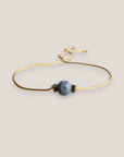 Minimalistisches Armband mit einer 8 mm großen hellblauen Schwammkorallenkugel und goldenen Trennelementen mit funkelnden weißen Kristallen.