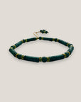 Pulsera con tubos y cuentas de lava verde oscuro y brillis oro con cristalitos color olivina