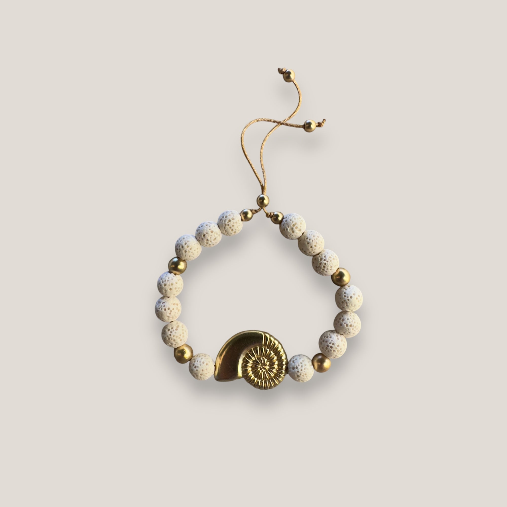 Pulsera con gran caracola y cuentas doradas con esponja coral blanca