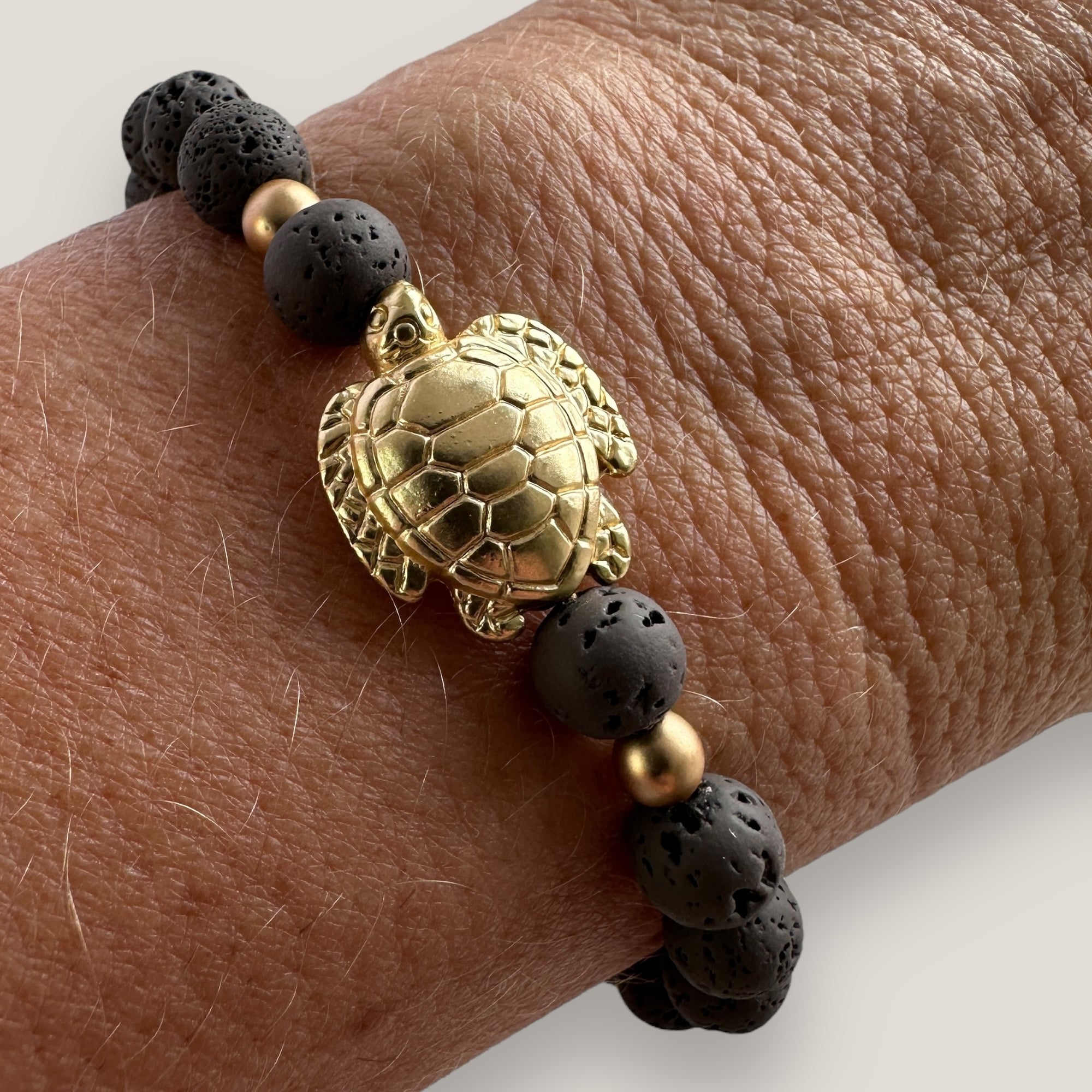 Bracelet with large golden turtle and colored lava