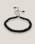 Pulsera Lilith con cuentas 4mm de lava negra y brillis gunmetal con cristalitos blancos
