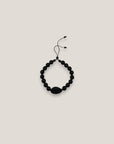 Pulsera cowrie negra mate ónix facetado pulido