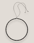 Collar mini base 4mm lava negra, rondeles plateados con cristalitos blancos
