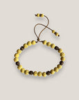 Pulsera Dafne con lava amarillo claro y filigrana bronce con cristalitos