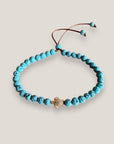 Pulsera con tortuguita dorada y lava azul turquesa