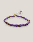 Pulsera con tubos y cuentas de lava malva y brillis oro con cristalitos rosas