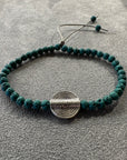 Pulsera pieza círculos concéntricos plateada con lava verde oscuro