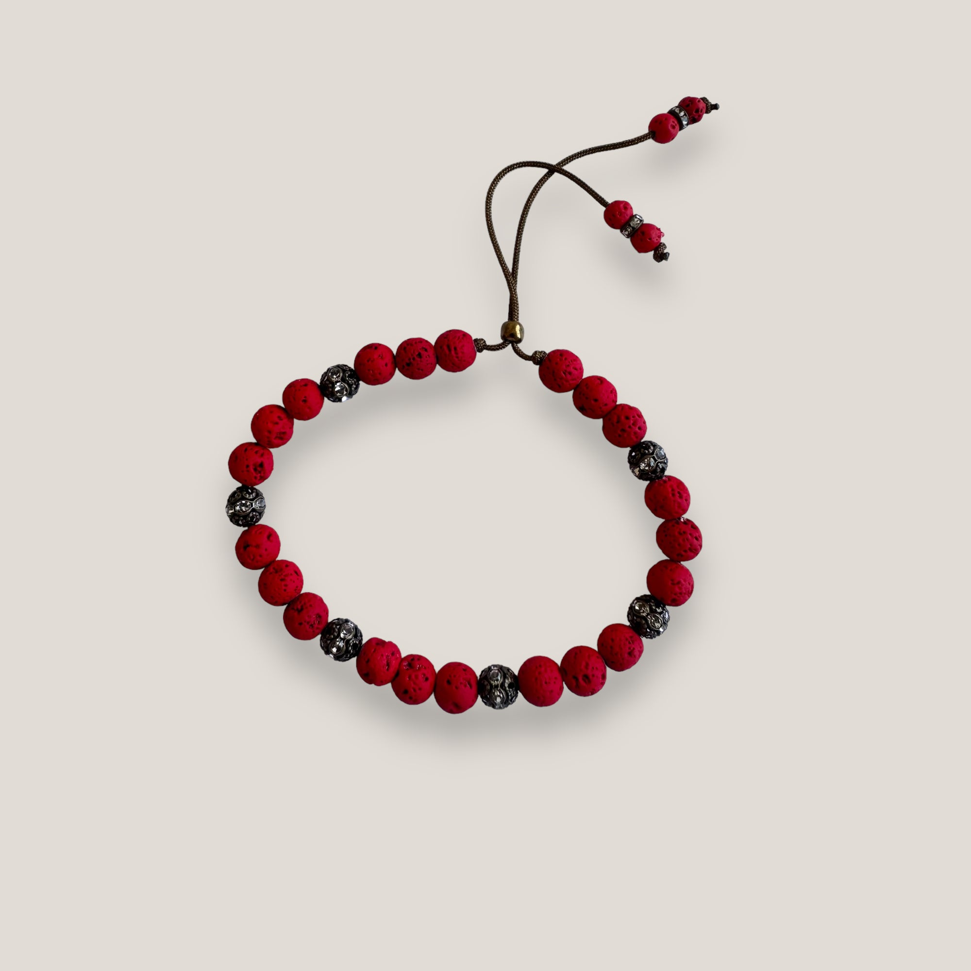 Pulsera Dafne con lava roja y filigranas bronce con cristalitoso