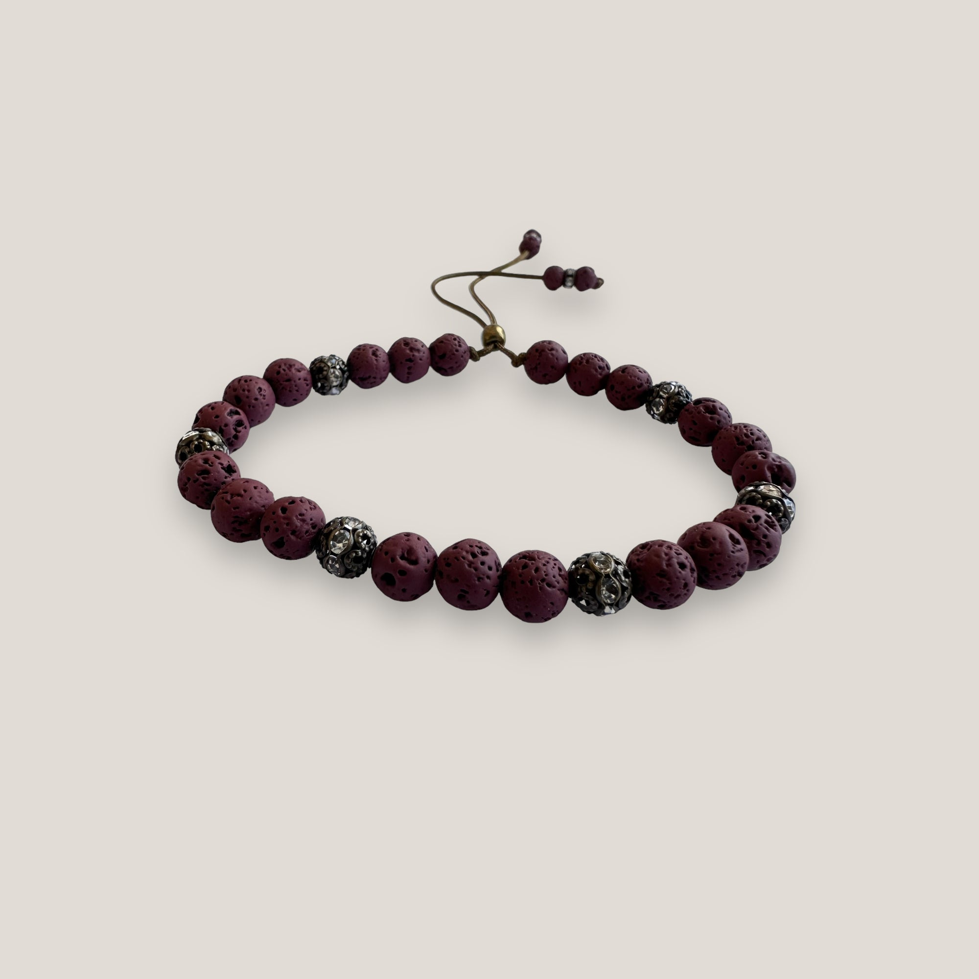Pulsera Dafne con lava granate y filigrana bronce con cristalitos