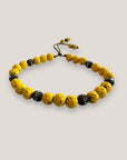 Pulsera Dafne con lava amarillo fuerte y filigrana bronce con cristalitos