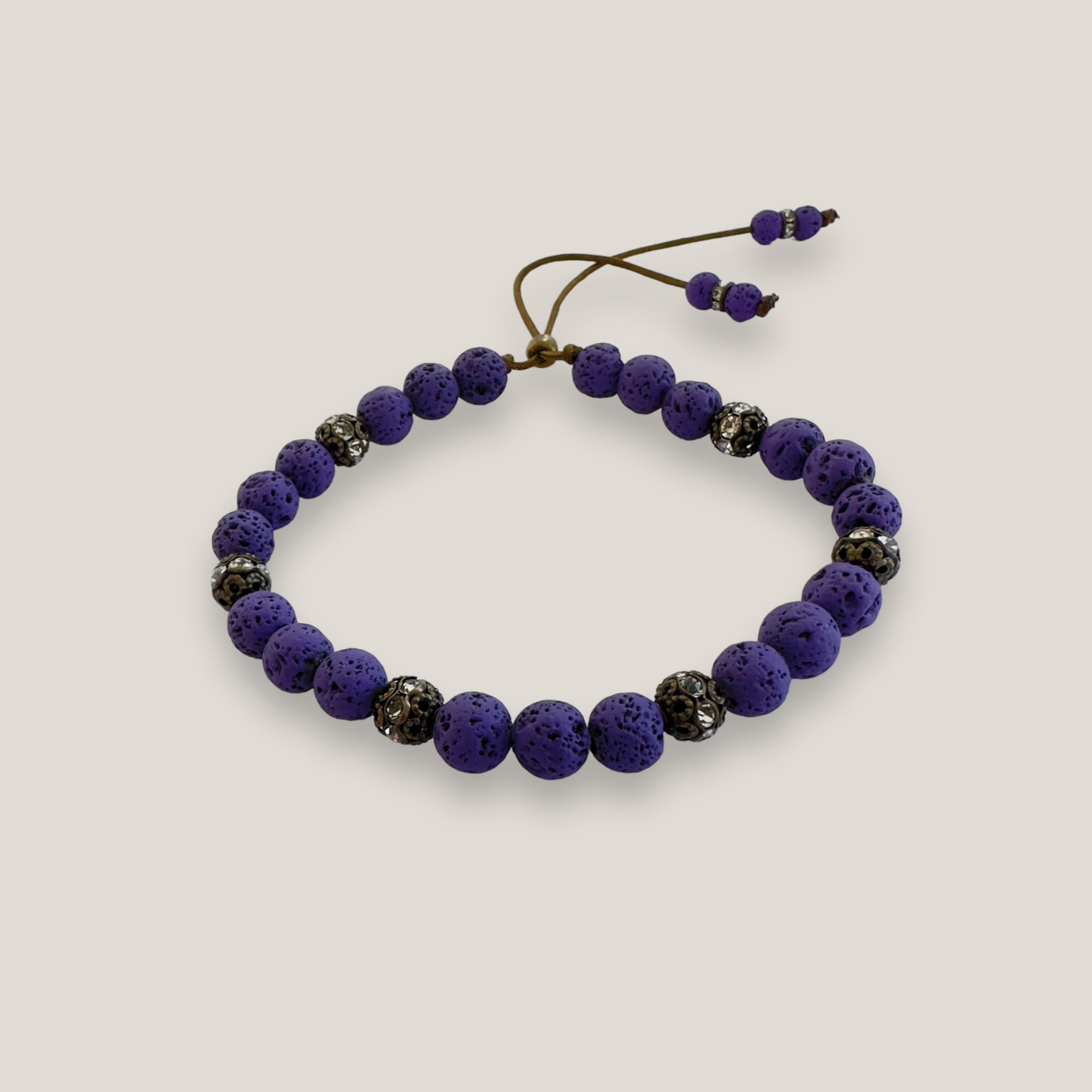 Pulsera Dafne con lava morada y filigrana bronce con cristalitos