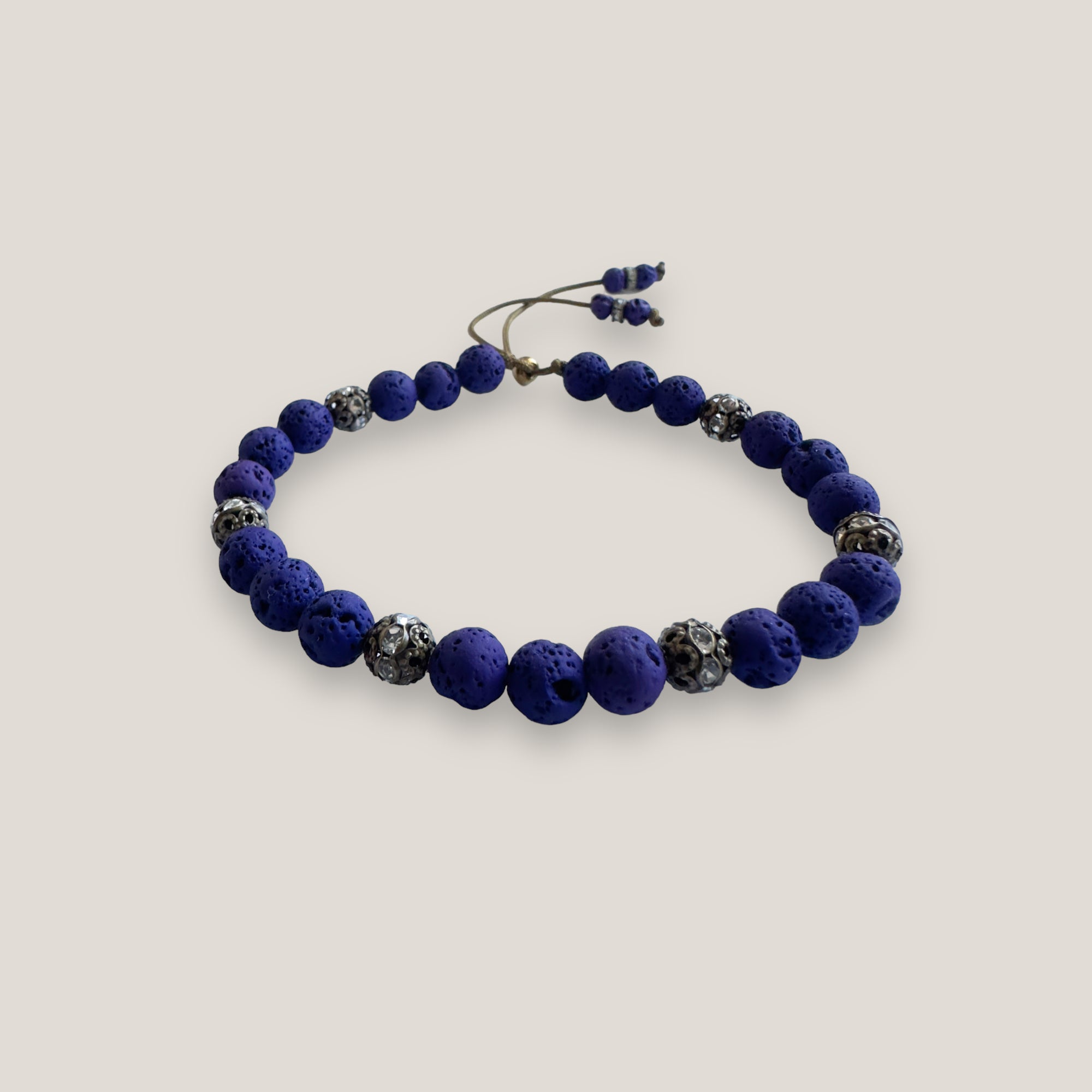 Pulsera Dafne con lava azul profundo y filigrana bronce con cristalitos