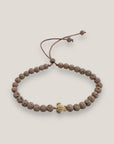 Pulsera con tortuguita dorada y lava marrón claro