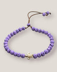 Pulsera con tortuguita dorada y lava malva