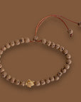 Pulsera con tortuguita dorada y lava marrón claro