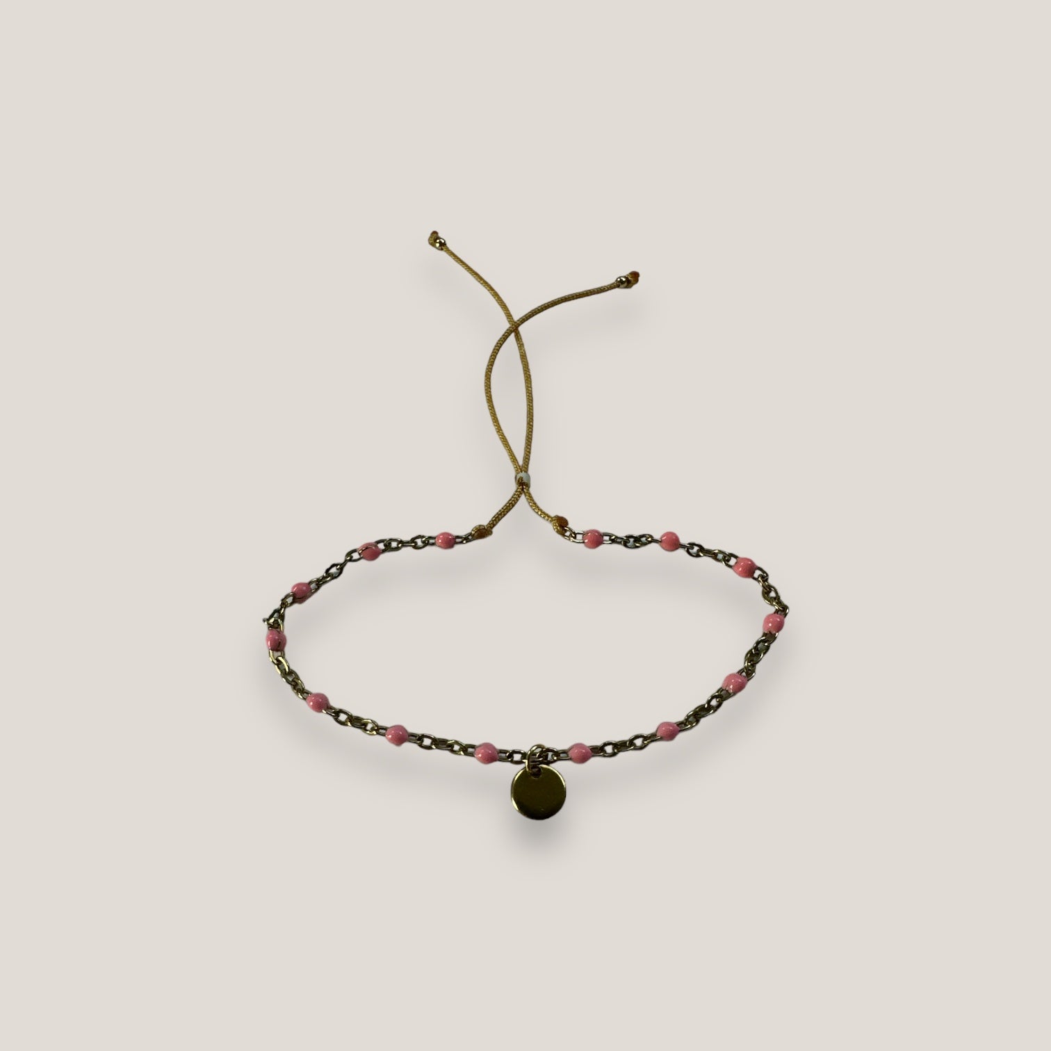 Kettenarmband und goldene Stahlmedaille mit rosa Emaille-Kugeln