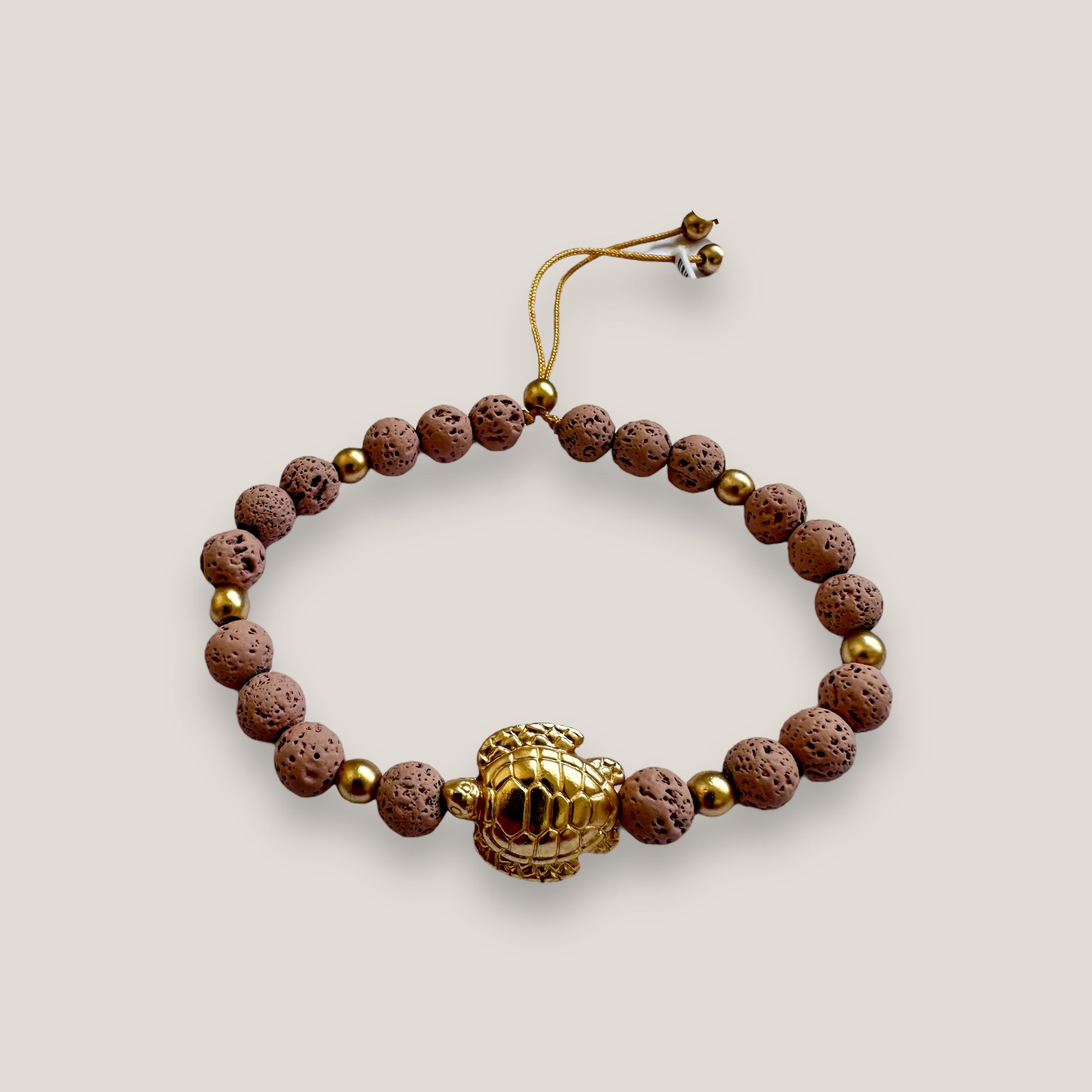 Bracelet with large golden turtle and colored lava
