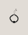 Pulsera cowrie negra mate lava negra