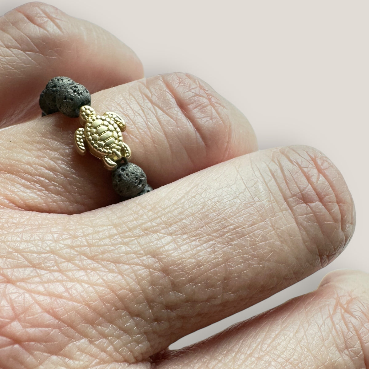 Golden turtle ring with colored lava beads