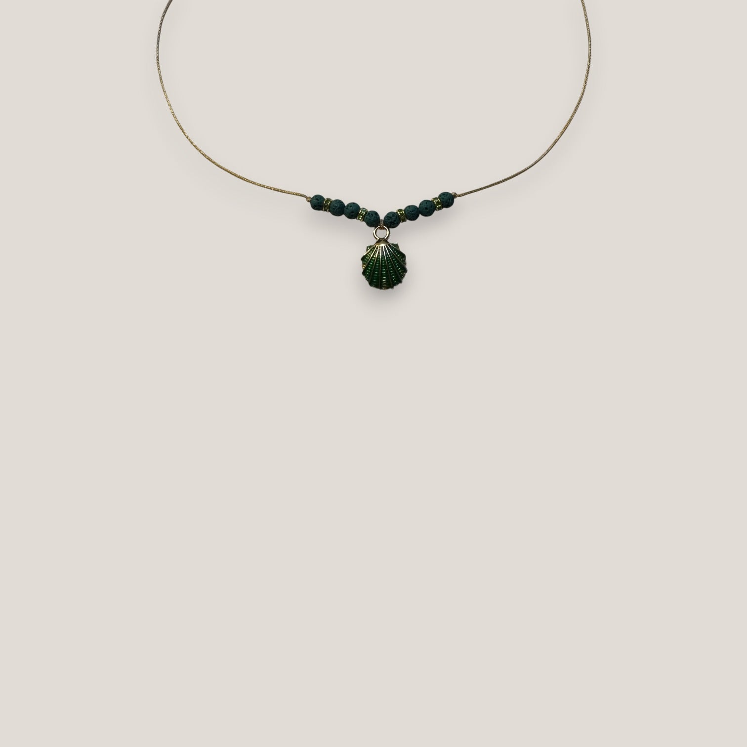 Collar midi con concha dorada esmaltada en verde con lava verde oscuro y separadores dorados con cristalitos verde olivina