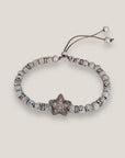 Pulsera con estrella plateada con brillis, lava blanca con separadores con más brillis