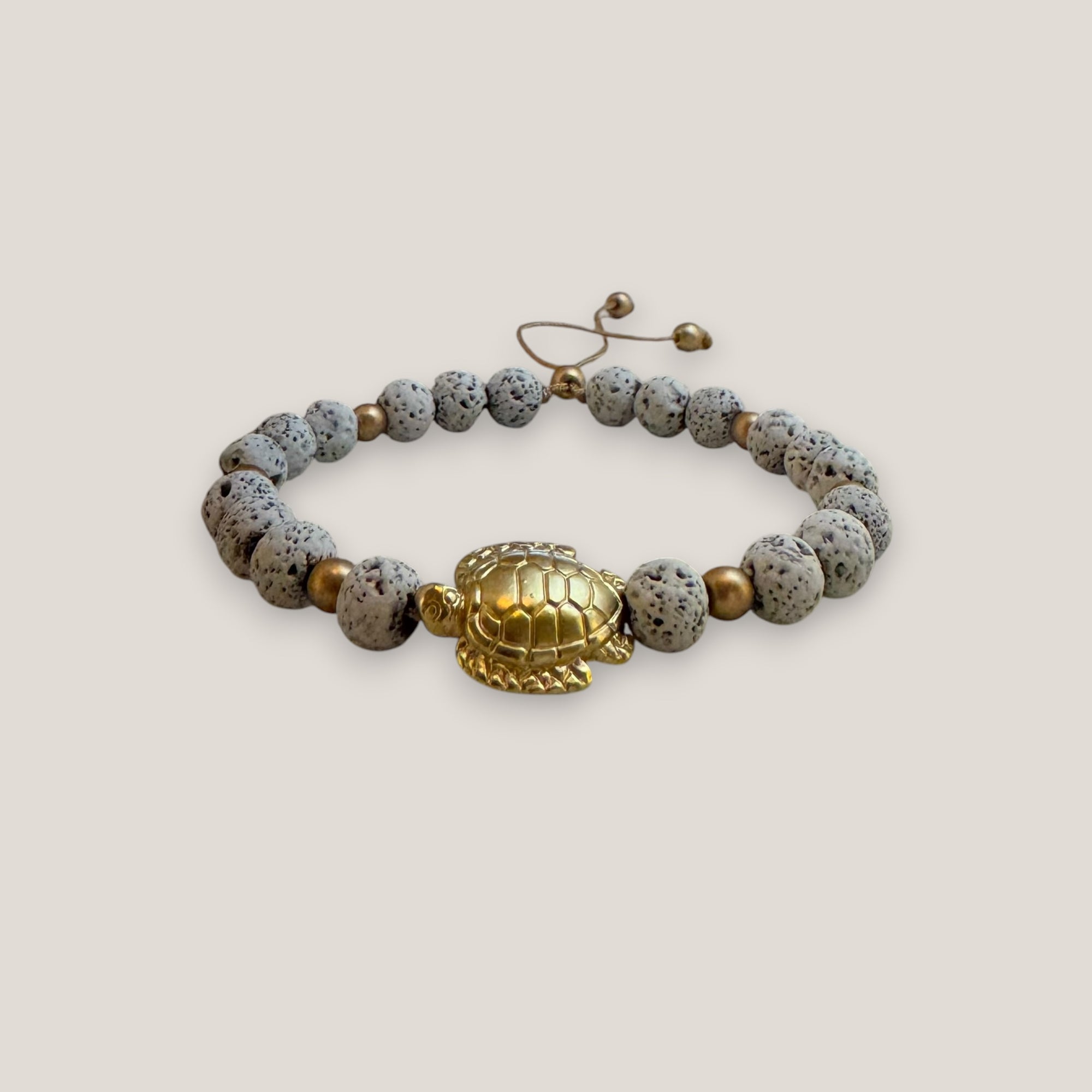 Pulsera con gran tortuga dorada lava blanca