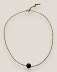 Collar minimal cadena acero oro con bola de lava negra