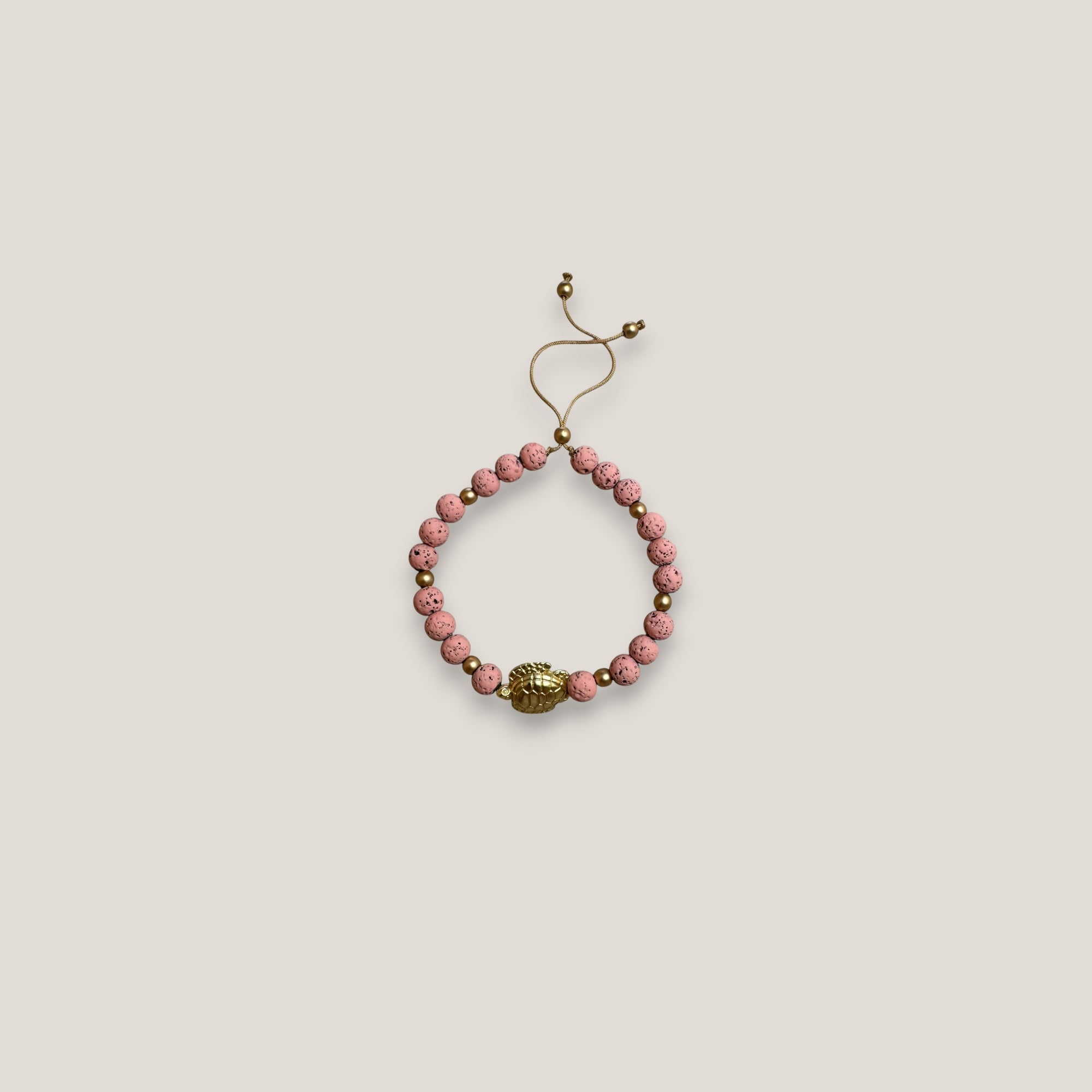 Armband mit großer goldener Schildkröte und rosa Lava