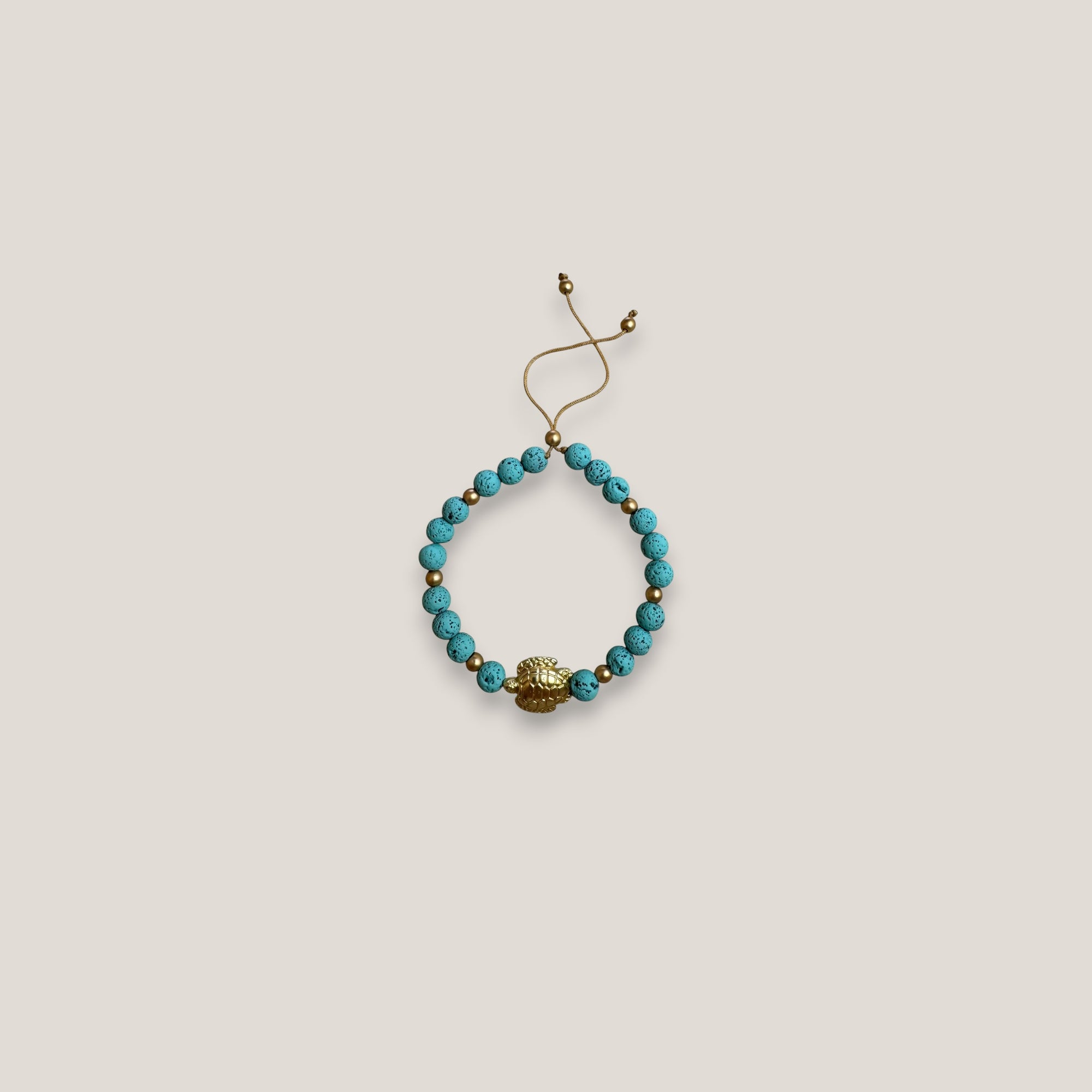 Pulsera con gran tortuga dorada lava azul turquesa