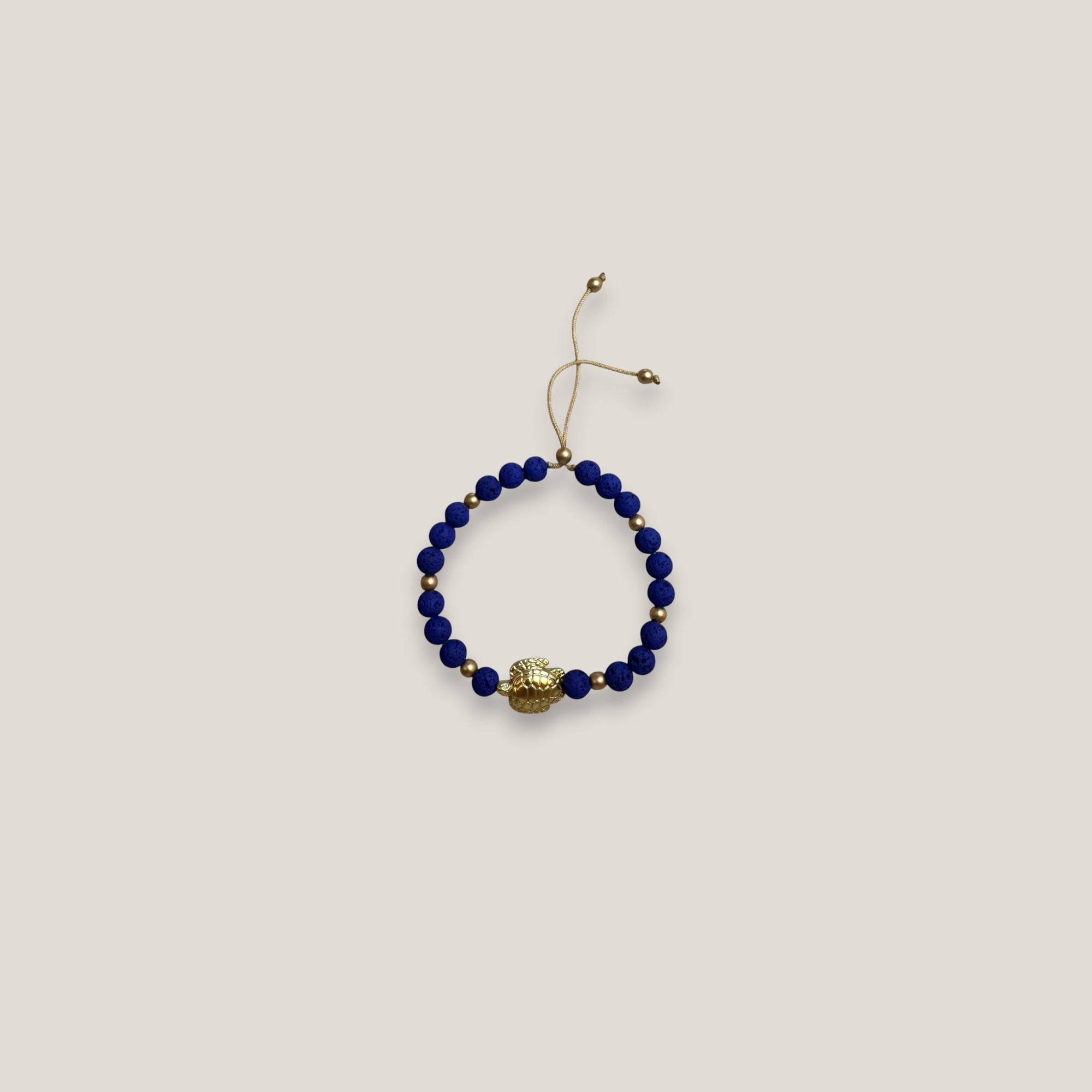 Pulsera con gran tortuga dorada lava azul azulón