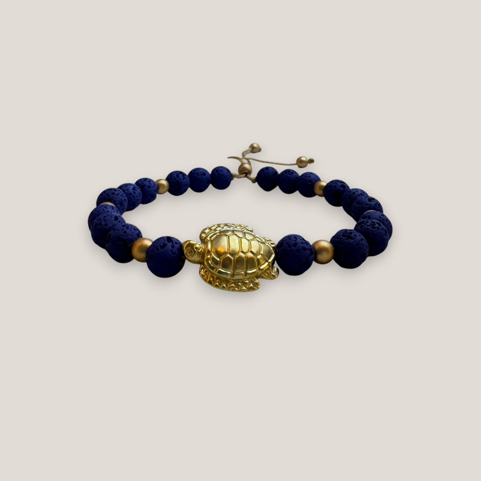 Pulsera con gran tortuga dorada lava azul azulón