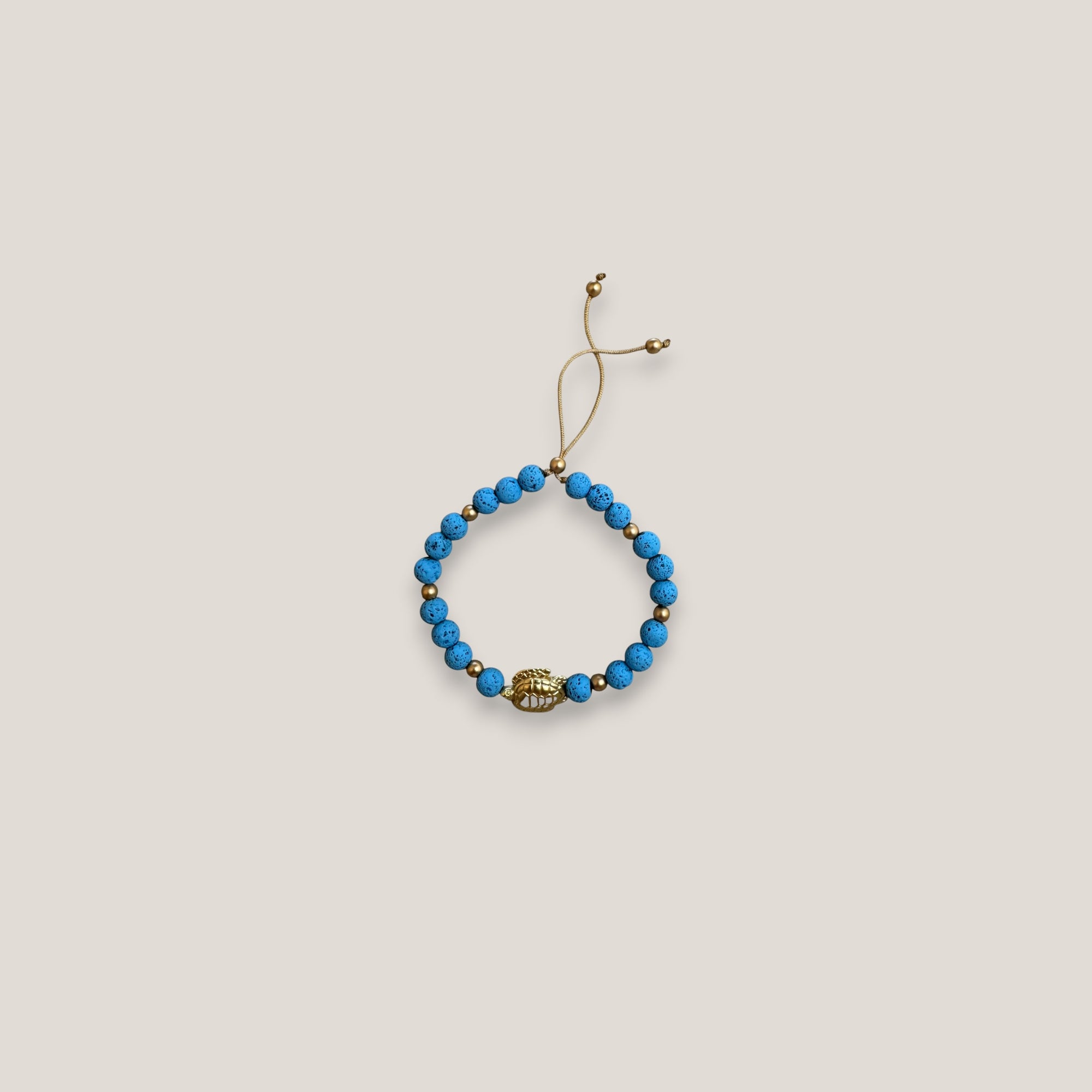 Pulsera con gran tortuga dorada lava azul azulín