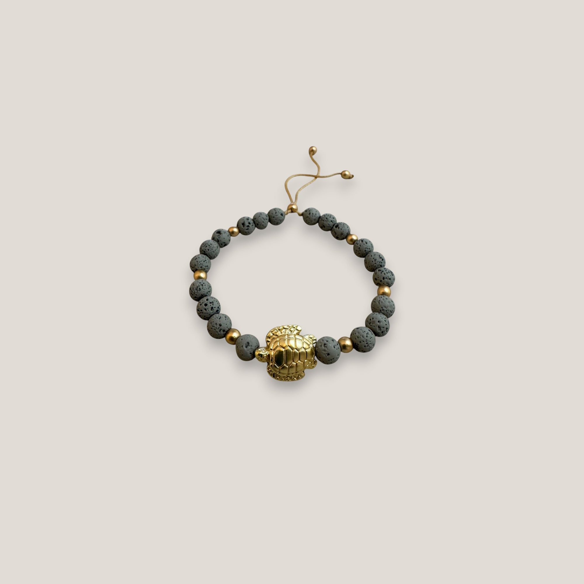 Pulsera con gran tortuga dorada lava gris claro