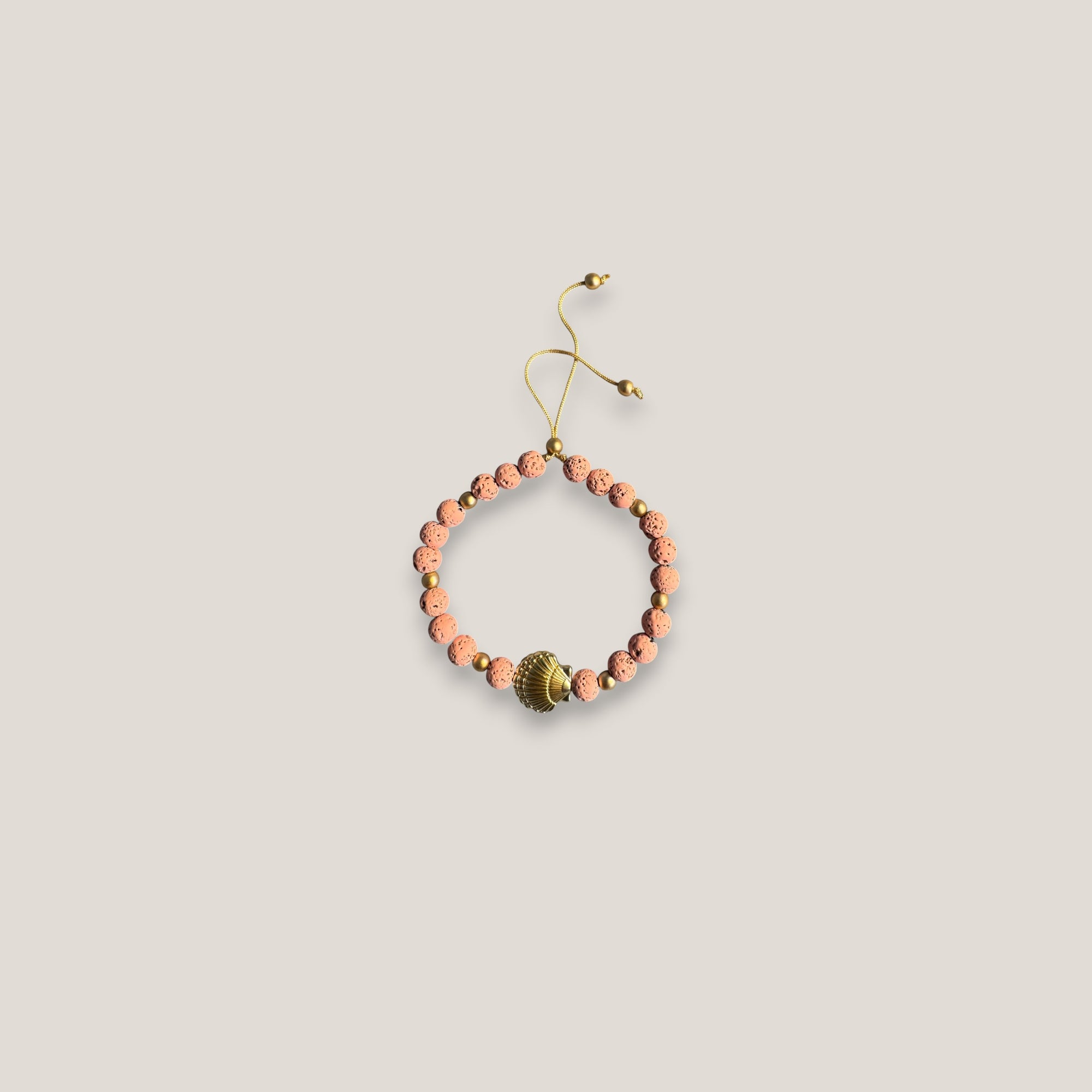 Pulsera gran concha dorada lava rosa