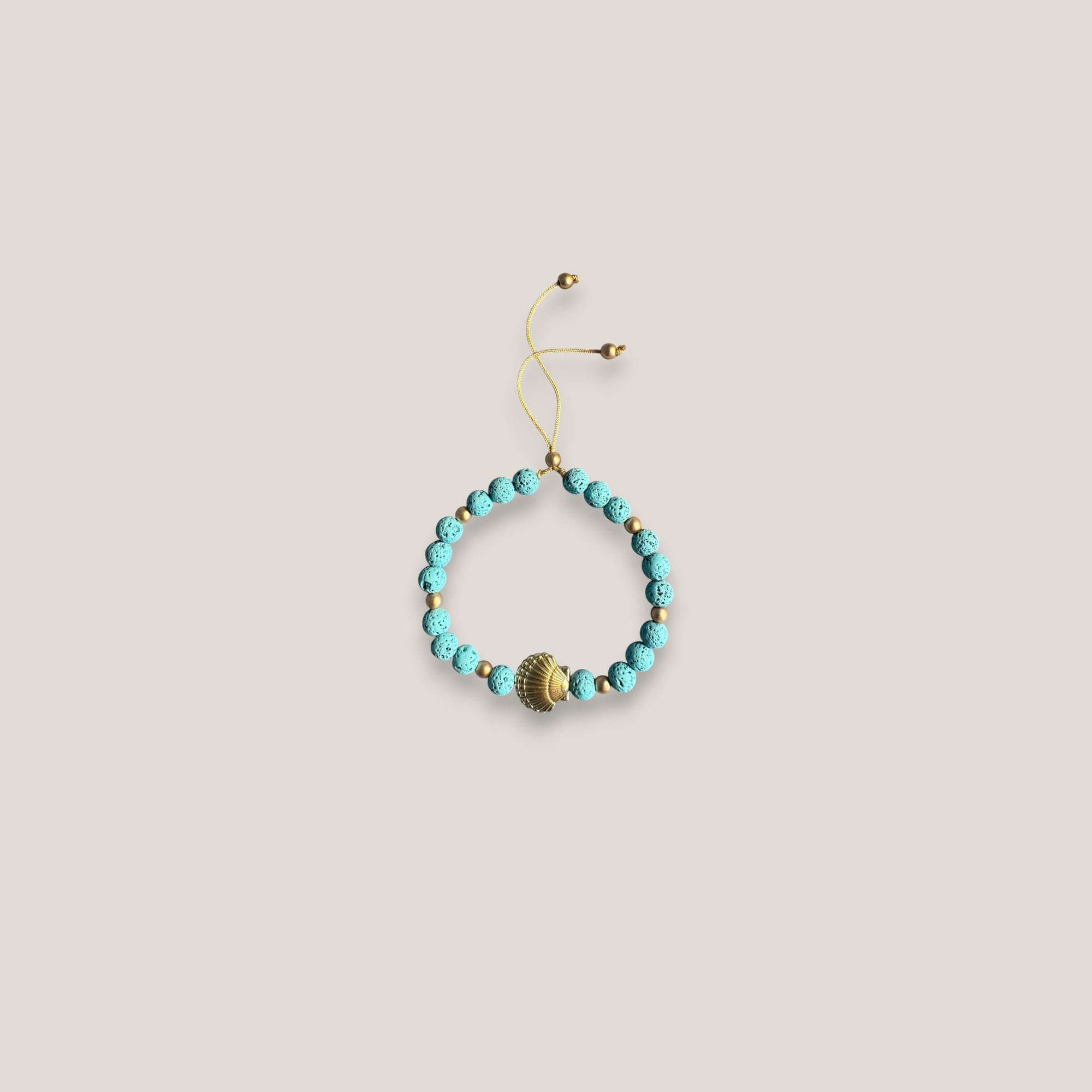 Pulsera gran concha dorada lava azul turquesa
