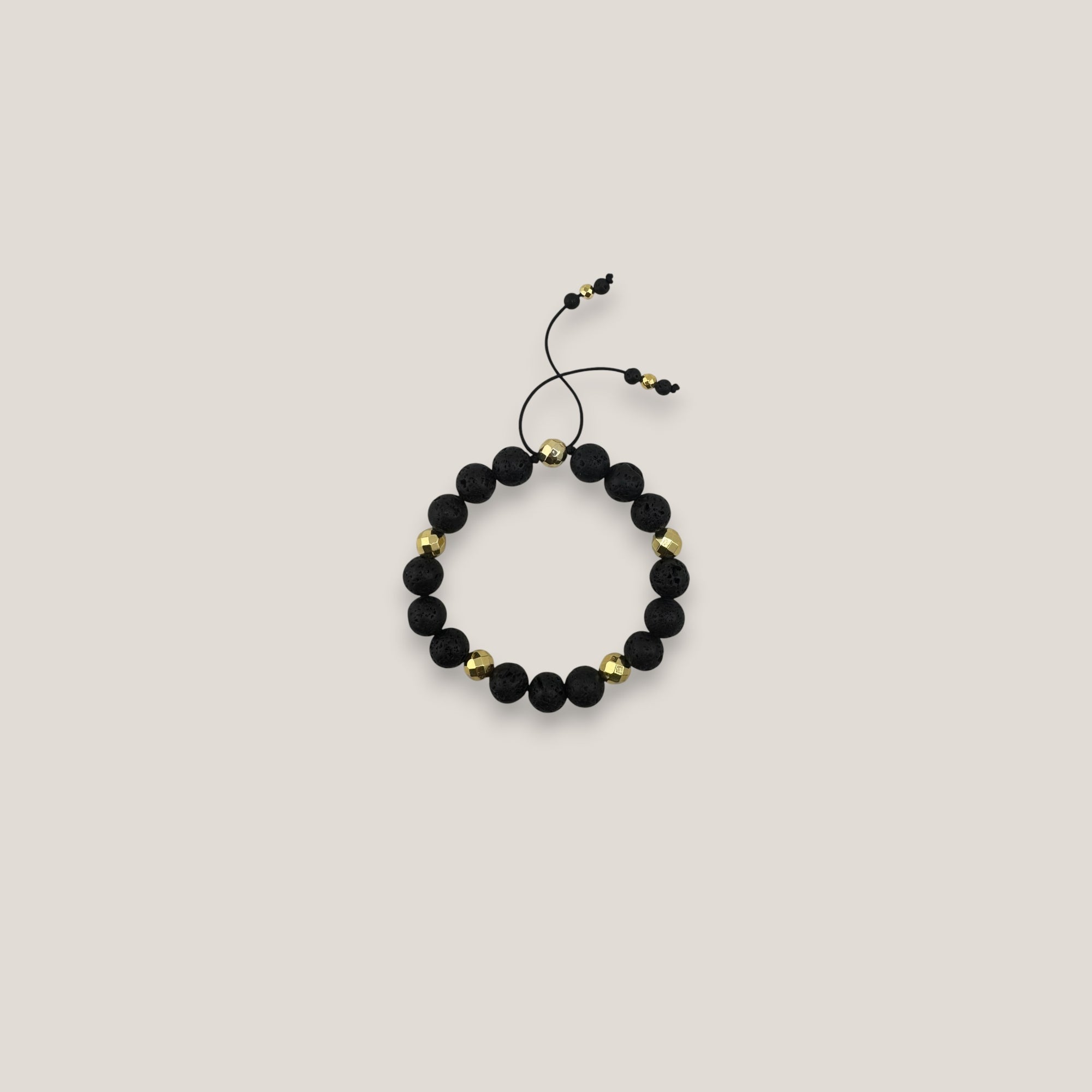 Pulsera base 10mm lava negra hematitas facetadas oro