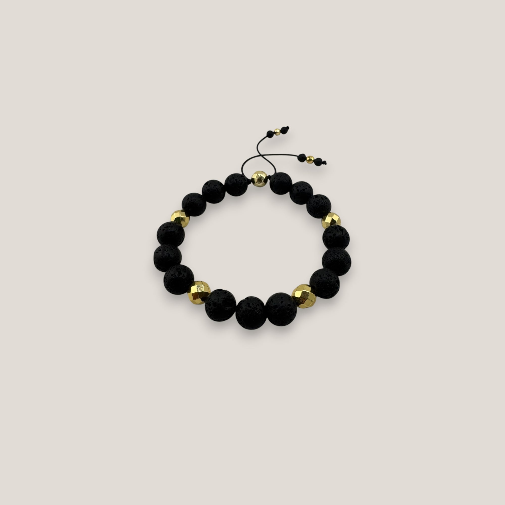Pulsera base 10mm lava negra hematitas facetadas oro