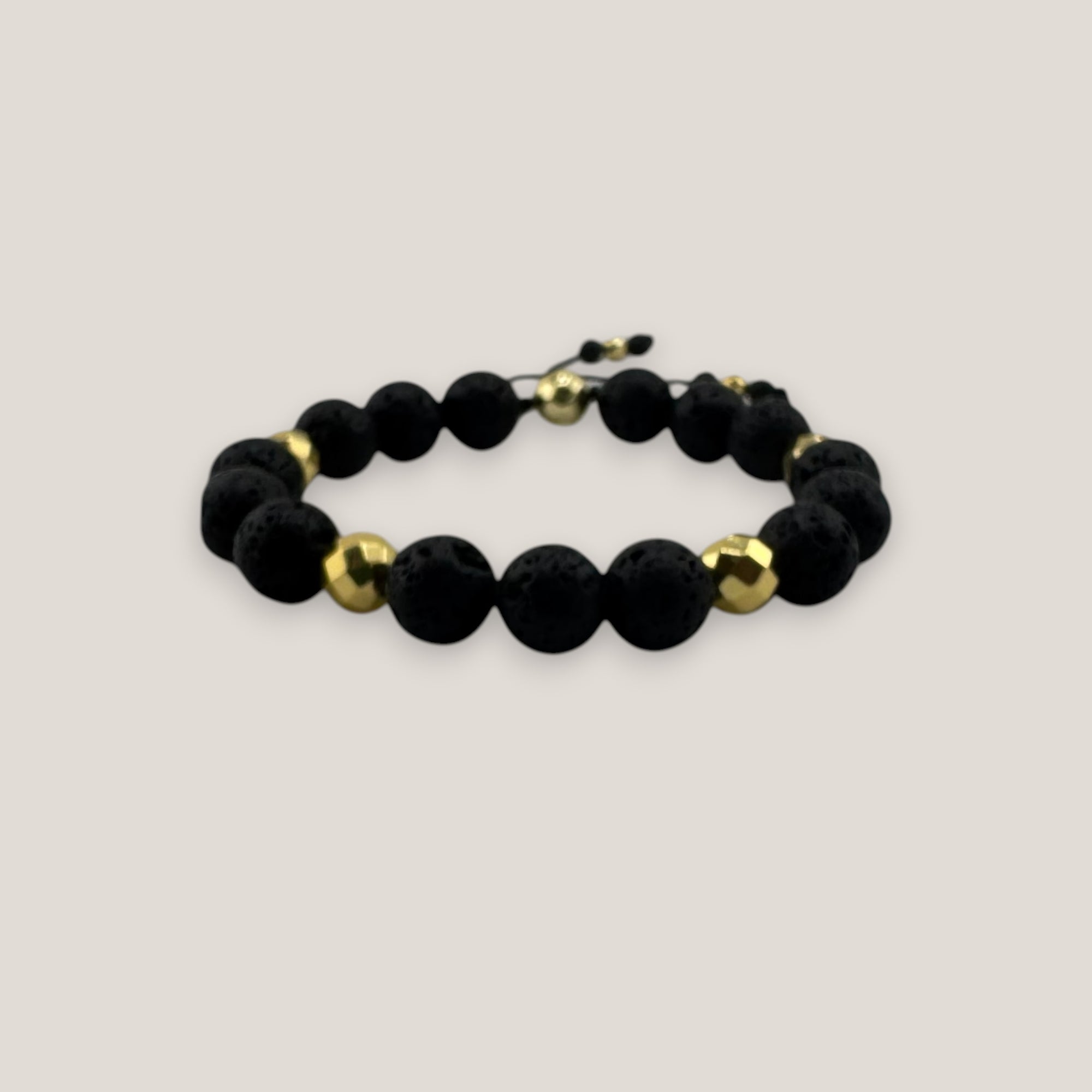Pulsera base 10mm lava negra hematitas facetadas oro