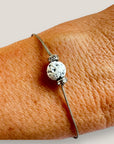 Pulsera minimal con bola de lava blanca y cuentas plata con brillis blancos