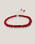 Pulsera con tubo, cuentas de lava roja y brillis oro con cristalitos rojos