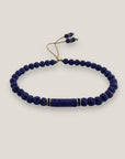 Pulsera con tubo, cuentas de lava azul profundo y brillis oro con cristalitos azules